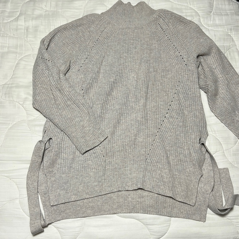 Turtleneck with side ties and stitching detail